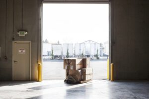  Pallets of boxed goods staged at a loading dock during load restocking for a waiting trailer.