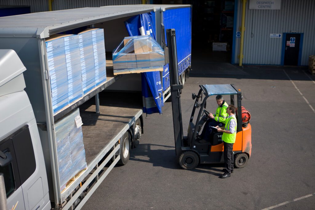 Truckload vs LTL shipping freight loading operation at warehouse dock