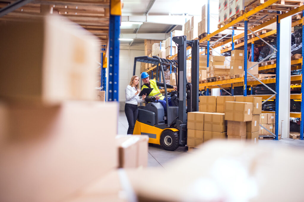 Forklift transferring freight during cross docking operations supporting warehouse overflow solutions